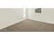 A bright bedroom with clean, neutral carpet and white walls with base trim at 19422 N Fiano Dr, Maricopa, AZ 85138