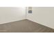 Neutral-toned bedroom with plush carpet and natural light from the window at 19422 N Fiano Dr, Maricopa, AZ 85138