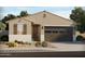 Charming single-story home featuring a well-manicured desert landscape and a two-car garage at 19422 N Fiano Dr, Maricopa, AZ 85138