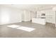 Open floor plan showcasing an island kitchen with pendant lights and modern appliances at 19422 N Fiano Dr, Maricopa, AZ 85138