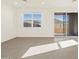 Bright living room featuring large windows, and tiled flooring at 19422 N Fiano Dr, Maricopa, AZ 85138