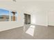 Bright living room featuring large windows, and tiled flooring at 19422 N Fiano Dr, Maricopa, AZ 85138