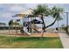 Shaded community playground featuring slides, ladders, and various play areas at 19422 N Fiano Dr, Maricopa, AZ 85138