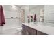 Bright bathroom features white subway tile, large vanity with quartz countertop, and shower-over-tub at 23081 E Saddle Way, Queen Creek, AZ 85142