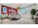 Stylish bedroom with a plush bed, modern decor, and large window at 23081 E Saddle Way, Queen Creek, AZ 85142