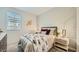 Stylish bedroom with an airplane wall decor, patterned wallpaper and metal-frame bed with luxe bedding at 23081 E Saddle Way, Queen Creek, AZ 85142