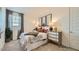 Inviting bedroom featuring neutral palette, large window, plush carpeting, and contemporary decor at 23081 E Saddle Way, Queen Creek, AZ 85142