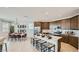 Open-concept kitchen with stainless steel appliances, a center island, and dining area at 23081 E Saddle Way, Queen Creek, AZ 85142