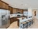 Well-equipped kitchen with stainless steel appliances, ample cabinet space, and a large center island at 23081 E Saddle Way, Queen Creek, AZ 85142