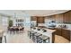 Open-concept kitchen with stainless appliances, large island with seating, and an adjacent dining area at 23081 E Saddle Way, Queen Creek, AZ 85142