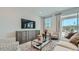 Comfortable living room with a large television, stylish furniture, and sliding door to an outdoor area at 23081 E Saddle Way, Queen Creek, AZ 85142