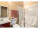 Bright bathroom featuring a glass shower, cherry vanity with sink, and decorative towels at 2526 W Florentine Rd, Phoenix, AZ 85086