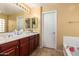 Bathroom featuring dual sinks, ample countertop space, and a separate tub at 2526 W Florentine Rd, Phoenix, AZ 85086