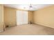 Spacious bedroom featuring a ceiling fan, carpet, and a large window for ample natural light at 2526 W Florentine Rd, Phoenix, AZ 85086