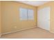 Neutral bedroom featuring a window with blinds, closet, carpet floors, and light-yellow painted walls at 2526 W Florentine Rd, Phoenix, AZ 85086