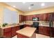 Well-equipped kitchen features rich wood cabinetry and a functional center island at 2526 W Florentine Rd, Phoenix, AZ 85086