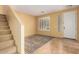 Inviting living room with tile flooring, staircase, and natural light from front door at 2526 W Florentine Rd, Phoenix, AZ 85086