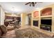 Open concept living space with cozy fireplace, kitchen, and dining area at 2526 W Florentine Rd, Phoenix, AZ 85086