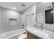 Stylish bathroom featuring modern fixtures, gray tile and a bathtub with shower at 3011 E John Cabot Dr, Phoenix, AZ 85032