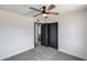 Bright bedroom features a ceiling fan and access to the ensuite bathroom and walk-in closet at 3011 E John Cabot Dr, Phoenix, AZ 85032
