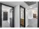 Hallway with white walls, black doors, views to the powder room and the kitchen at 3011 E John Cabot Dr, Phoenix, AZ 85032