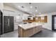 Newly remodeled kitchen with large island, white cabinets, stainless appliances, and modern backsplash at 3011 E John Cabot Dr, Phoenix, AZ 85032