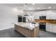 Updated kitchen with granite countertops, island with seating, stainless steel appliances and herringbone backsplash at 3011 E John Cabot Dr, Phoenix, AZ 85032