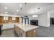 Spacious kitchen with granite island, white cabinets, and decorative backsplash, flowing into the living room at 3011 E John Cabot Dr, Phoenix, AZ 85032