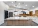 Open kitchen featuring granite countertops, center island with pendant lights and stainless appliances at 3011 E John Cabot Dr, Phoenix, AZ 85032