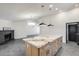 Modern kitchen with large island and lighting, stainless steel appliances, and black brick fireplace at 3011 E John Cabot Dr, Phoenix, AZ 85032