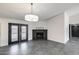 Bright living room features black brick fireplace, grey tiled floors and glass paned french doors at 3011 E John Cabot Dr, Phoenix, AZ 85032