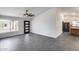 Bright living space featuring stylish gray tile floors, a modern ceiling fan, and a view of the kitchen at 3011 E John Cabot Dr, Phoenix, AZ 85032