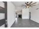Open-concept living space with sleek gray tile flooring, vaulted ceilings, and a cozy fireplace at 3011 E John Cabot Dr, Phoenix, AZ 85032