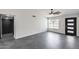 Neutral living area with gray tile flooring, a modern ceiling fan, and ample natural light at 3011 E John Cabot Dr, Phoenix, AZ 85032