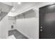 Functional mudroom with built-in shelving, coat hooks, and tile flooring, offering ample storage space at 3011 E John Cabot Dr, Phoenix, AZ 85032