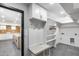 Mudroom with marble bench and coat hooks connects to a kitchen with granite counters and herringbone backsplash at 3011 E John Cabot Dr, Phoenix, AZ 85032