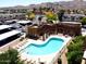 Aerial view showcases a community pool, covered parking, and nearby desert mountain views at 3434 E Baseline Rd # 214, Phoenix, AZ 85042