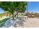 Community grilling area with seating and shade trees in a common community area at 3434 E Baseline Rd # 214, Phoenix, AZ 85042