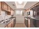 Galley-style kitchen boasts natural light, cabinetry, and appliances at 3434 E Baseline Rd # 214, Phoenix, AZ 85042