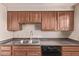 This kitchen features wood cabinets, tile backsplash, and a stainless steel sink at 3434 E Baseline Rd # 214, Phoenix, AZ 85042