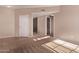 Open-concept living room featuring tile flooring, neutral carpeting and fresh paint at 3434 E Baseline Rd # 214, Phoenix, AZ 85042