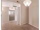 Living room space with neutral carpeting, tile flooring, a light fixture and a doorway at 3434 E Baseline Rd # 214, Phoenix, AZ 85042