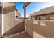Outdoor balcony area with stucco walls and a view of the complex's architecture at 3434 E Baseline Rd # 214, Phoenix, AZ 85042