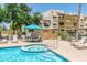 Resort-style pool, tables, chairs, and a grill area available for community residents at 3434 E Baseline Rd # 214, Phoenix, AZ 85042