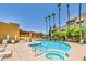 Community pool and spa area with lounge chairs, palm trees, and multiple residential buildings at 3434 E Baseline Rd # 214, Phoenix, AZ 85042