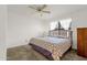 Tranquil bedroom featuring soft carpet, a large window, and a ceiling fan at 3491 N Arizona Ave # 118, Chandler, AZ 85225