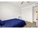 Cozy bedroom features neutral carpet, closet, and a comfy blue bedspread at 3491 N Arizona Ave # 118, Chandler, AZ 85225