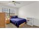 Well-lit bedroom with a ceiling fan, a large window, and ample storage space at 3491 N Arizona Ave # 118, Chandler, AZ 85225
