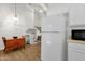 Bright eat-in kitchen showcasing white appliances, including a refrigerator and views to the stairway at 3491 N Arizona Ave # 118, Chandler, AZ 85225