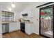 Functional kitchen with white cabinets, modern appliances, and patio access at 3491 N Arizona Ave # 118, Chandler, AZ 85225
